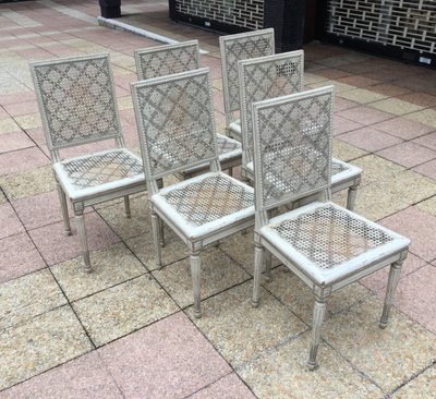 Set of six Louis XVI caned chairs in rechampi wood.