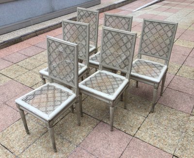 Set of six Louis XVI caned chairs in rechampi wood.