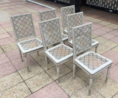 Set of six Louis XVI caned chairs in rechampi wood.