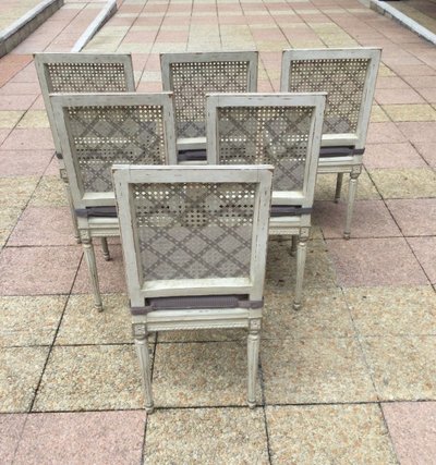 Set of six Louis XVI caned chairs in rechampi wood.