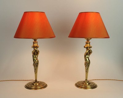 Pair of bronze "Atlantean" lamps