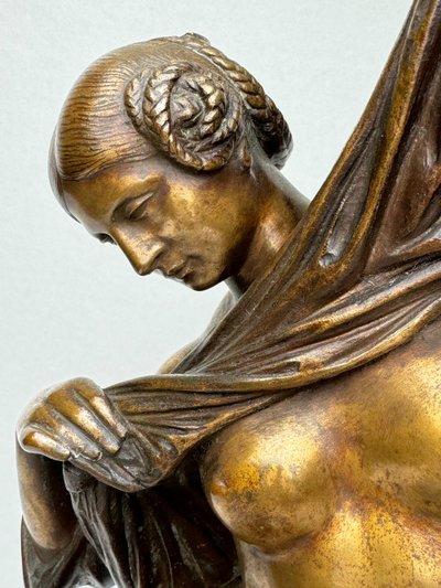 Bronze Sculpture of a Seated Woman Undressing