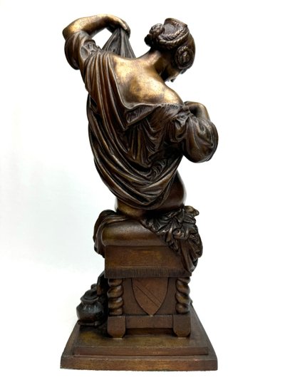 Bronze Sculpture of a Seated Woman Undressing