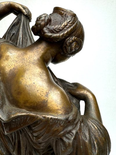 Bronze Sculpture of a Seated Woman Undressing