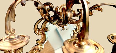 Pair of rococo style wall lights in gilded bronze and mirror