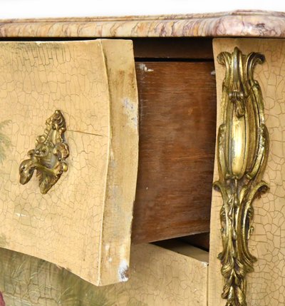 Louis XV style chest of drawers in lacquered wood with polychrome Chinese decoration on a beige background