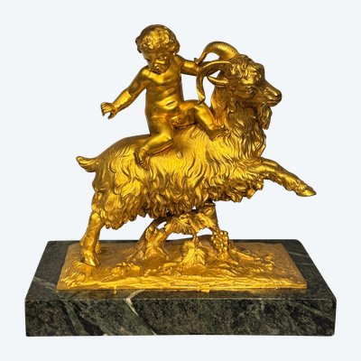 Scultura in bronzo dorato Bacco o putto su capra XIX secolo