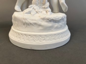 Pair of candlestick in cookie of Sevres with putti