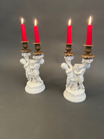 Pair of candlestick in cookie of Sevres with putti