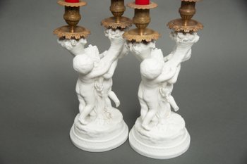 Pair of candlestick in cookie of Sevres with putti