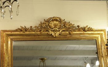 Grand miroir en bois et stuc doré, XIXème siècle 