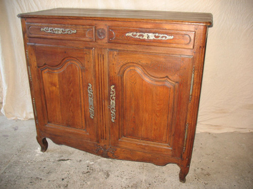 Low sideboard in molded and carved oak in the Louis XV style, 19th century