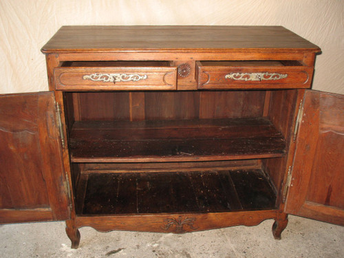 Low sideboard in molded and carved oak in the Louis XV style, 19th century