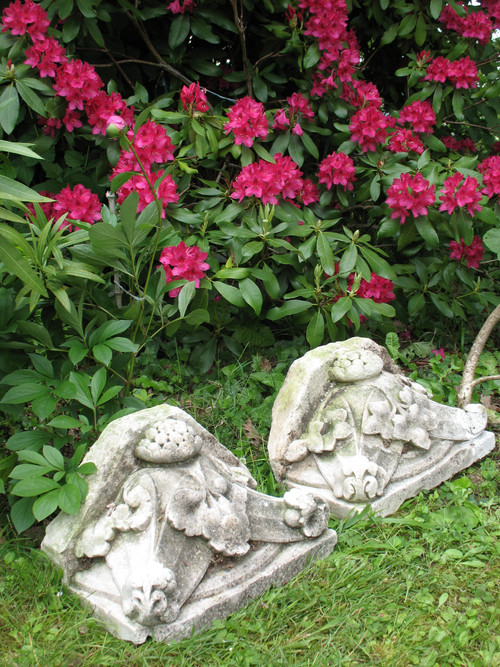 Pair of gothic style stone wall brackets decorated with plants