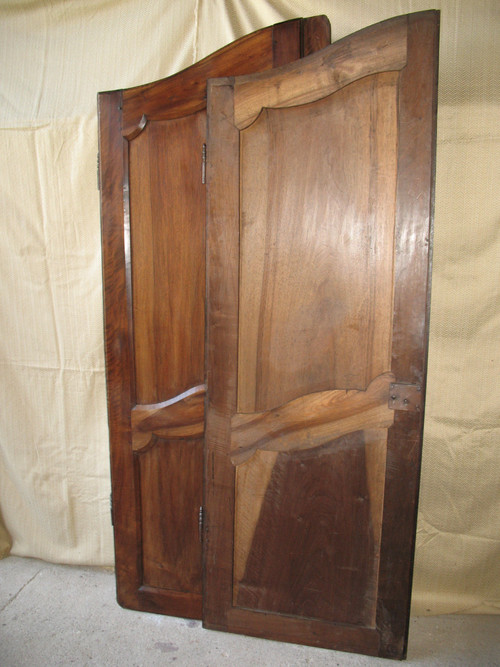 Pair of Louis XV style walnut paneled doors, 19th century