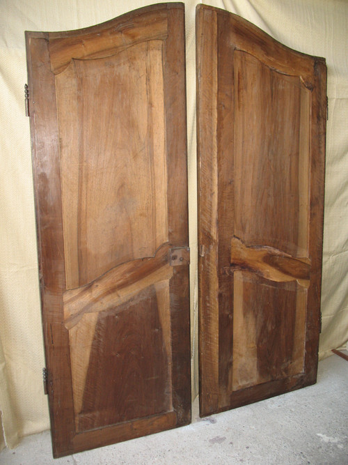 Pair of Louis XV style walnut paneled doors, 19th century