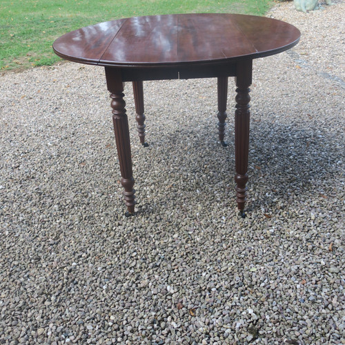 Round mahogany table with extension leaf