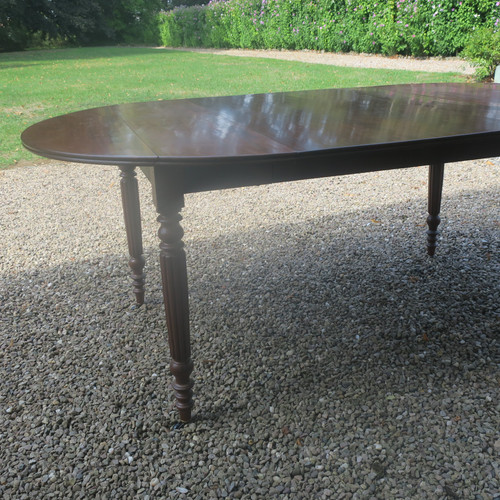 Round mahogany table with extension leaf