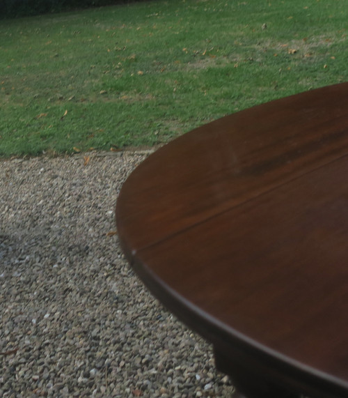 Round mahogany table with extension leaf