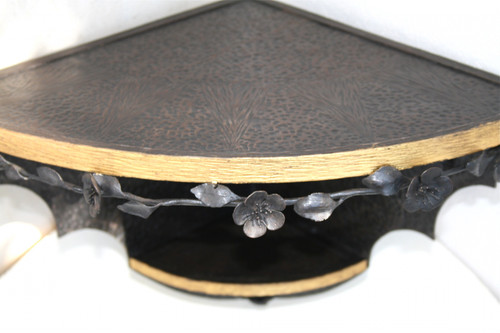 Pair of small corner consoles, wrought and gilded iron, signed, circa 1925