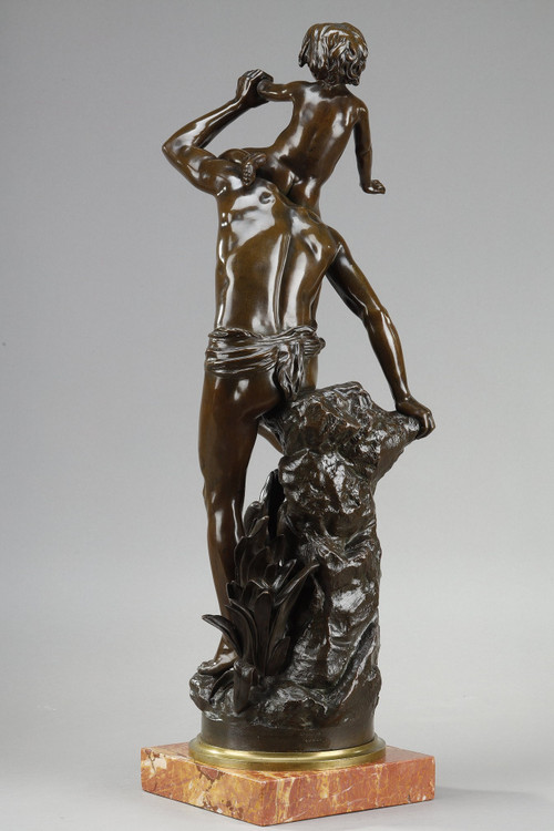 BROWN PATINA BRONZE OF A MAN CARRYING A CHILD ON HIS BACK, BY GASTON LEROUX (1854-1942)