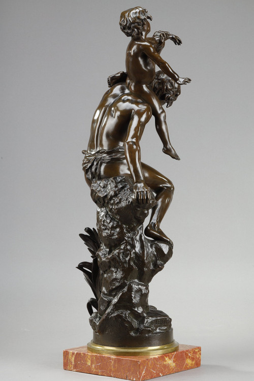 BROWN PATINA BRONZE OF A MAN CARRYING A CHILD ON HIS BACK, BY GASTON LEROUX (1854-1942)