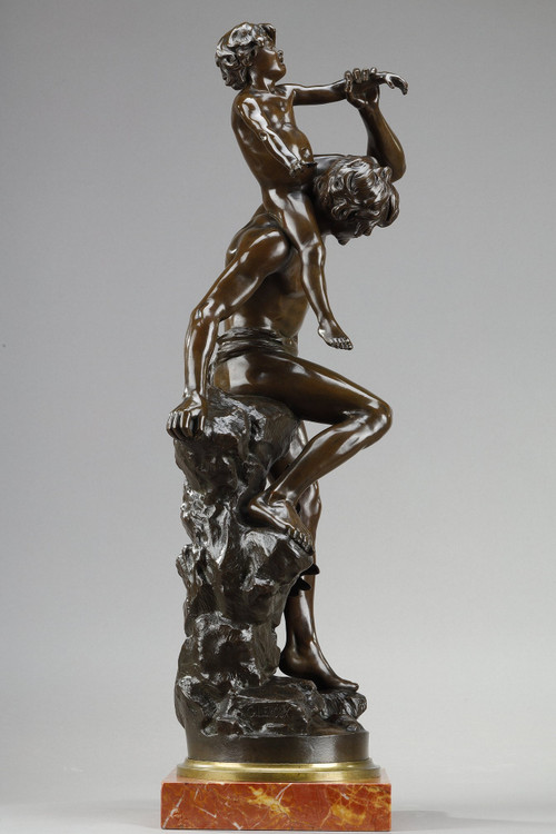 BROWN PATINA BRONZE OF A MAN CARRYING A CHILD ON HIS BACK, BY GASTON LEROUX (1854-1942)