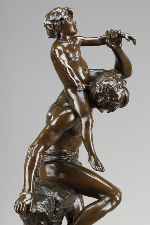 BROWN PATINA BRONZE OF A MAN CARRYING A CHILD ON HIS BACK, BY GASTON LEROUX (1854-1942)