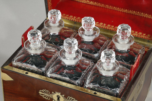 FLAMED MAHOGANY LIQUEUR CELLAR WITH CUT CRYSTAL BOTTLES AND GLASSES