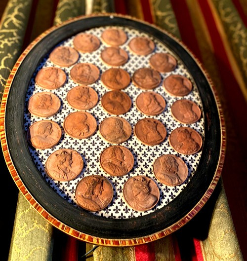  Large oval frame with representation in terracotta medallions of the oldest Kings up to the descendants of "Louis XVI"