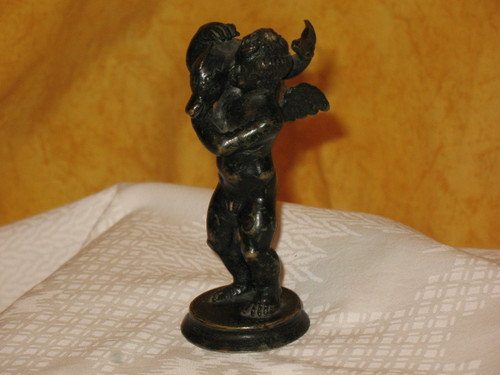 Bronze sculpture of the cherub and the dolphin in the Grand Tour style from the 20th century.