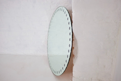 Large Fornasetti style optical mirror.