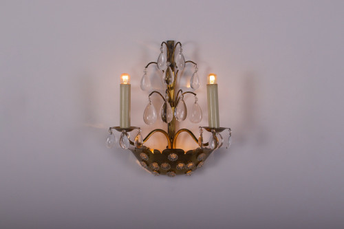 Brass floral sconce with pendants.