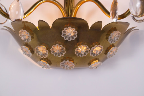 Brass floral sconce with pendants.