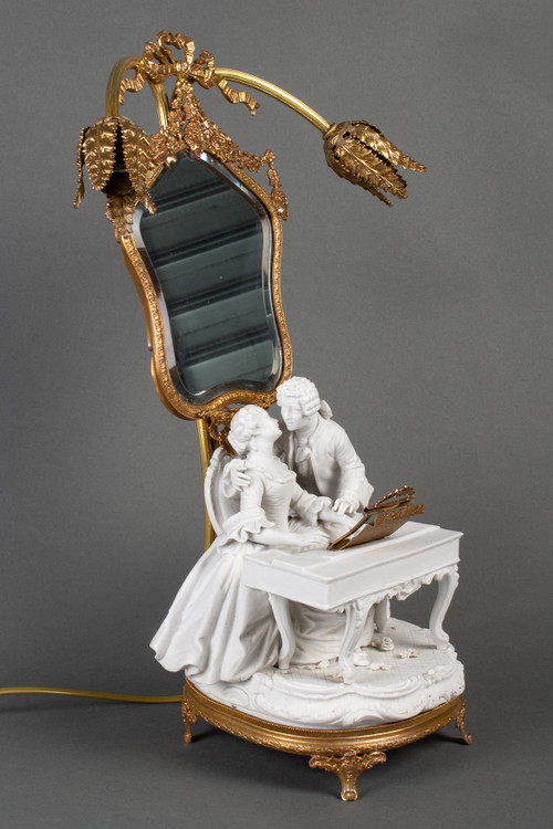 A romantic group in biscuit mounted lamp late 19th century