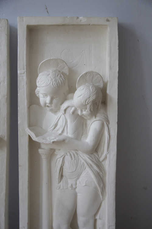 FRENCH school of the 20th century after DONATELLO (1386-1466), suite of two plaster bas-reliefs.