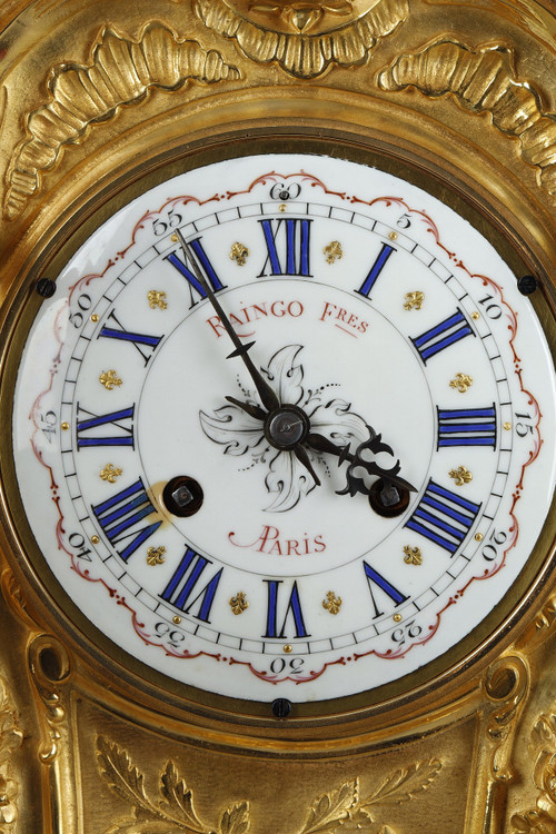 ORMOLU AND CHASED BRONZE ROCAILLE CLOCK, RAINGO AND BROTHERS 