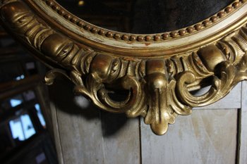 Antique Napoleon III oval mirror in gilded Louis XV style