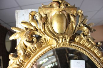 Antique Napoleon III oval mirror in gilded Louis XV style