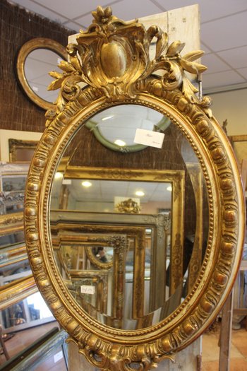 Antique Napoleon III oval mirror in gilded Louis XV style