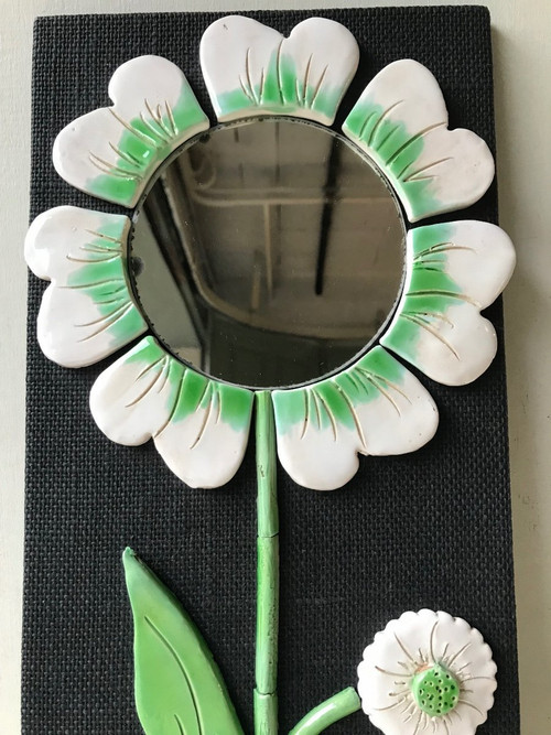 Ceramic flower mirror.