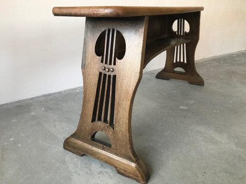 Art and Crafts style organ bench in solid oak.