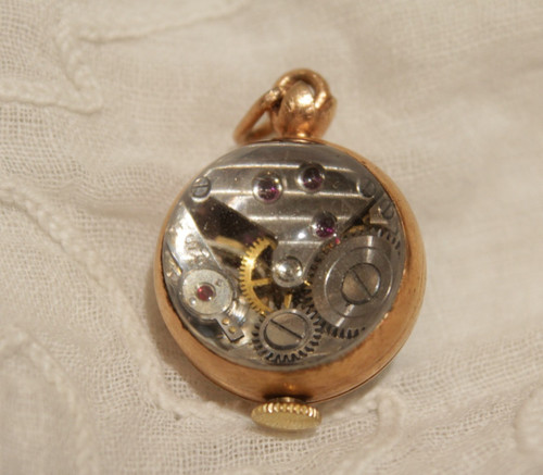 Small ball watch pendant with visible winding mechanism, 20th century period