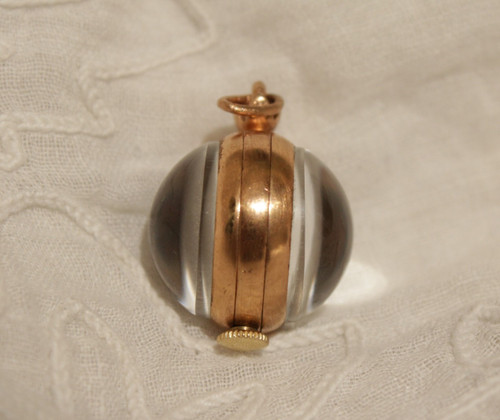 Small ball watch pendant with visible winding mechanism, 20th century period