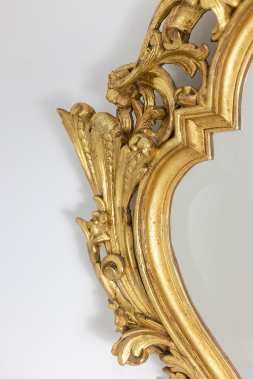 Regency style mirror in carved and gilded wood. 1950s.