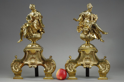 PAIR OF ORMOLU AND CHASED ANDIRONS DECORATED WITH SEATED MUSES