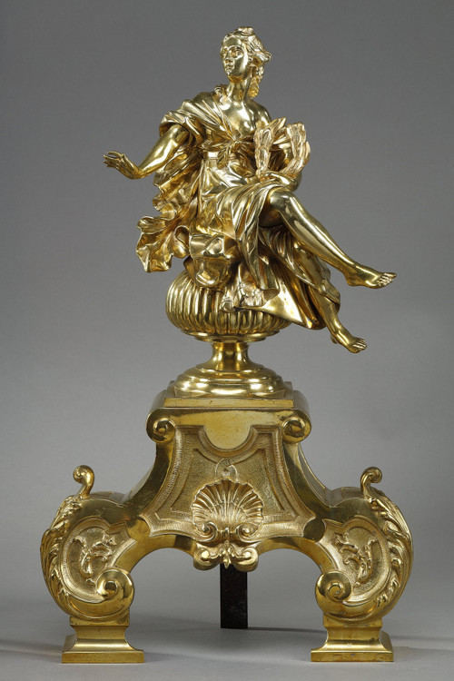 PAIR OF ORMOLU AND CHASED ANDIRONS DECORATED WITH SEATED MUSES