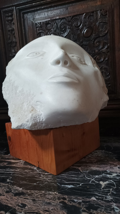 Face bust stone sculpture