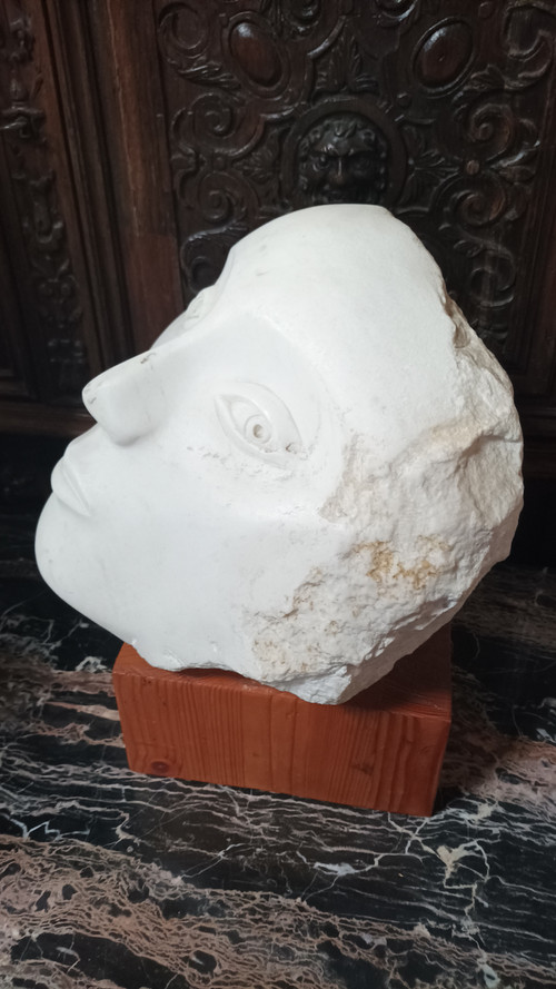 Face bust stone sculpture