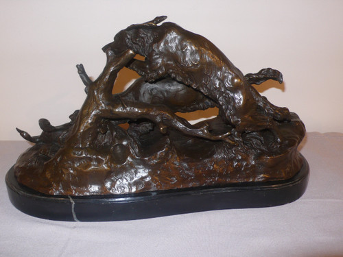 Bronze representing two hunting dogs and a duck.